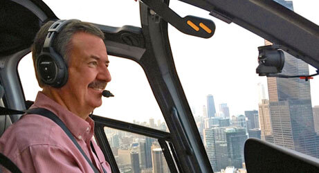 Chuck Surack, owner of Surack Enterprises flying helicopter