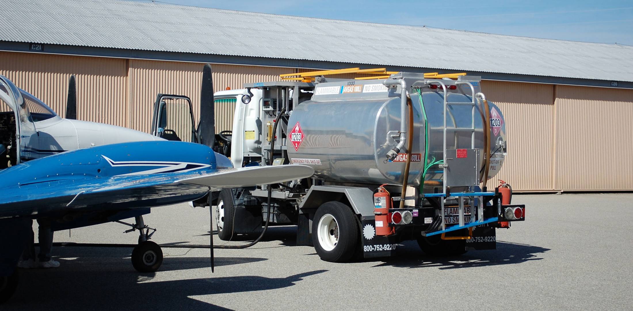 Avgas fuel truck refuels twin piston aircraft