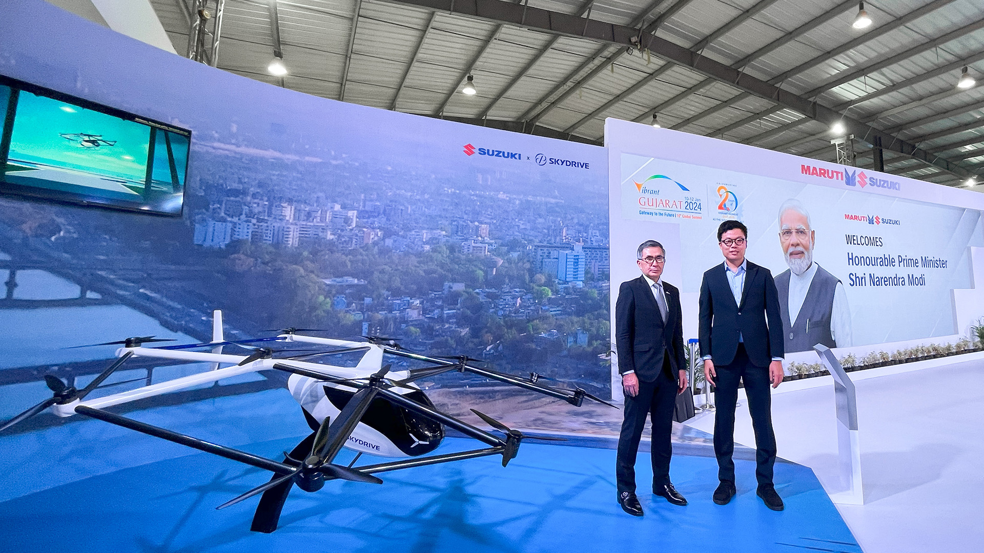 Suzuki president Toshihiro Suzuki (left) and SkyDrive CEO Tomohiro Fukuzawa with a scale-model of the SD-05 eVTOL aircraft.