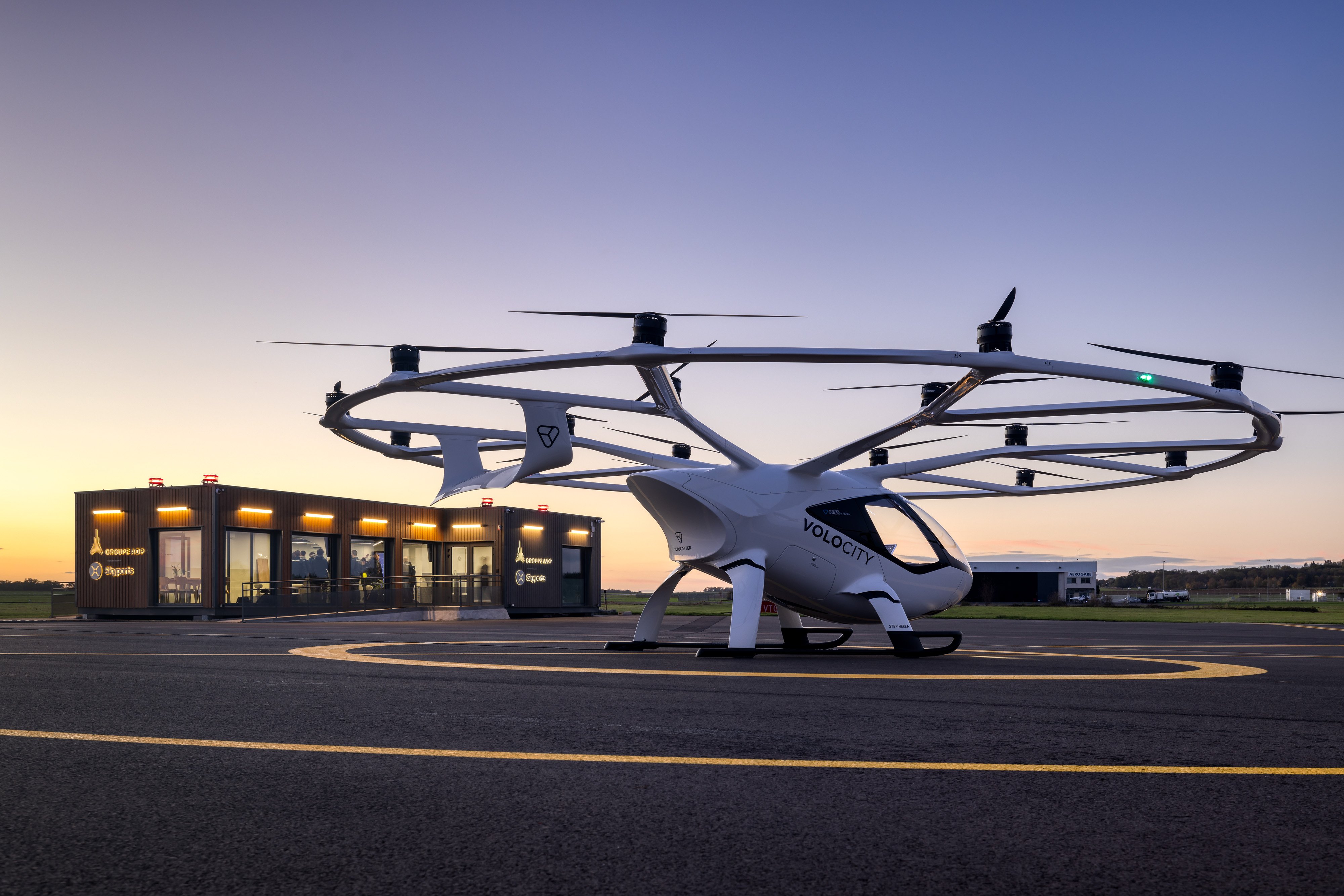 Volocopter's VoloCity eVTOL aircraft next to the vertiport facility at Pontoise-Cormeilles Airport near Paris.