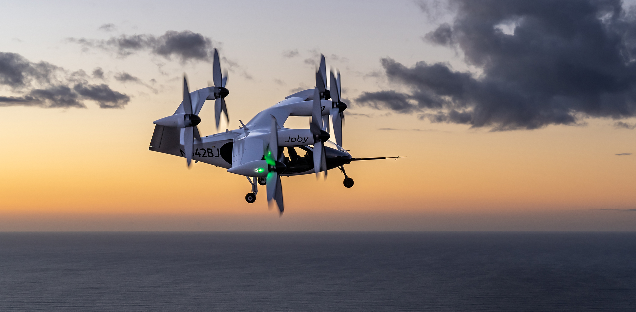 Joby's eVTOL air taxi is pictured in flight above the Pacific Ocean