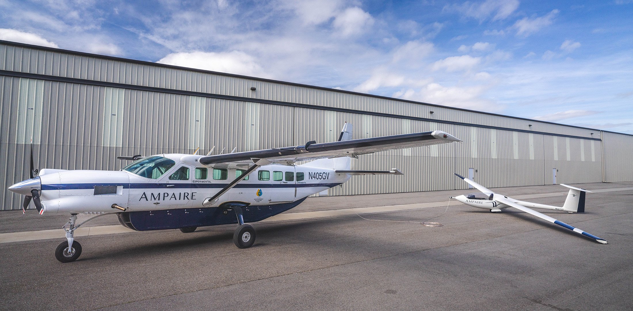 Ampaire's Eco Caravan is pictured outside the company's hangar at Camarillo Airport in California. The Eco Caravan is tethered to a PIK-20D glider that Magpie has been using to test its electric aircraft tug.