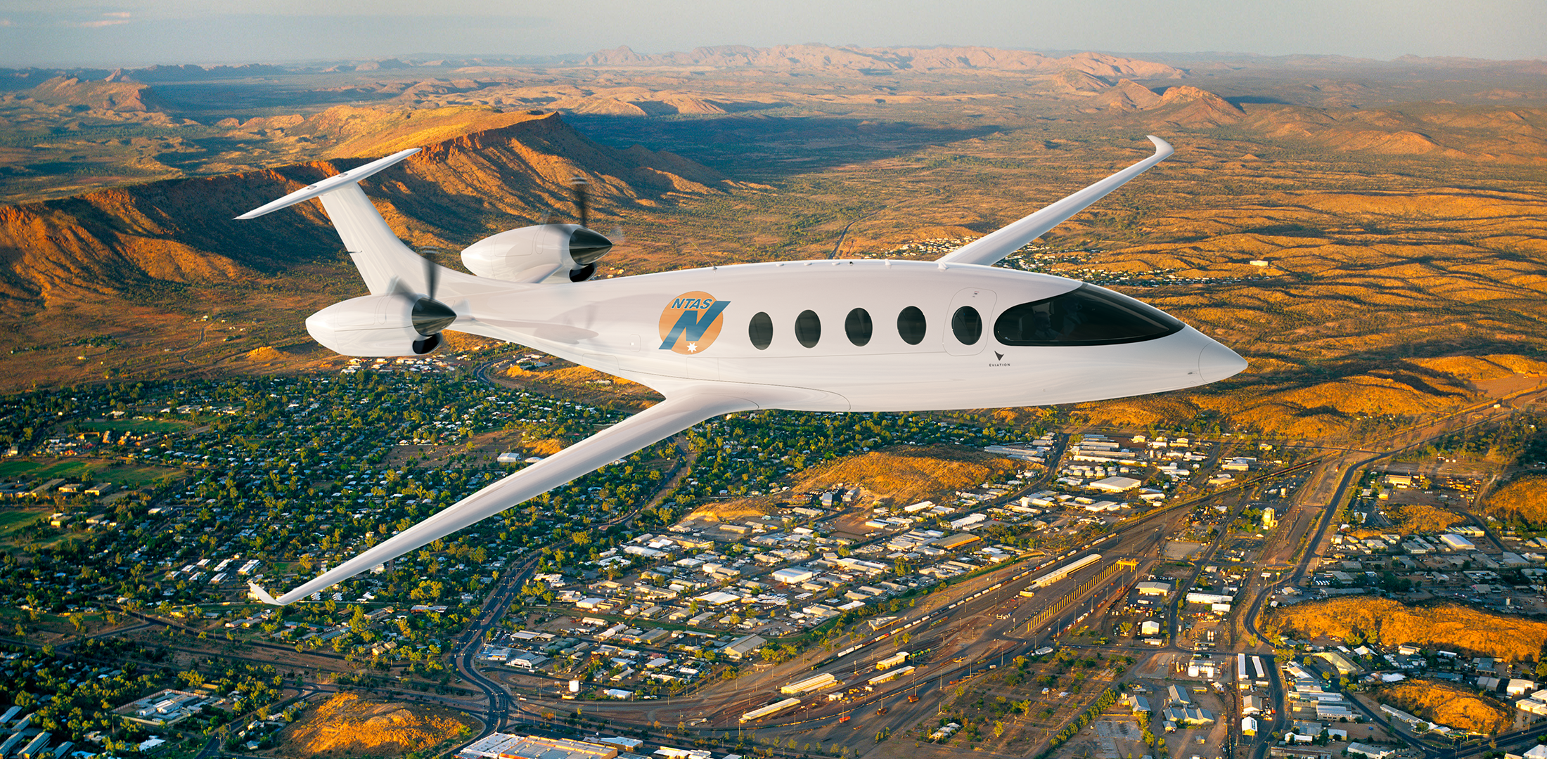 An Eviation Alice airplane with an NTAS logo flies over the Australian outback in this digitally rendered image.