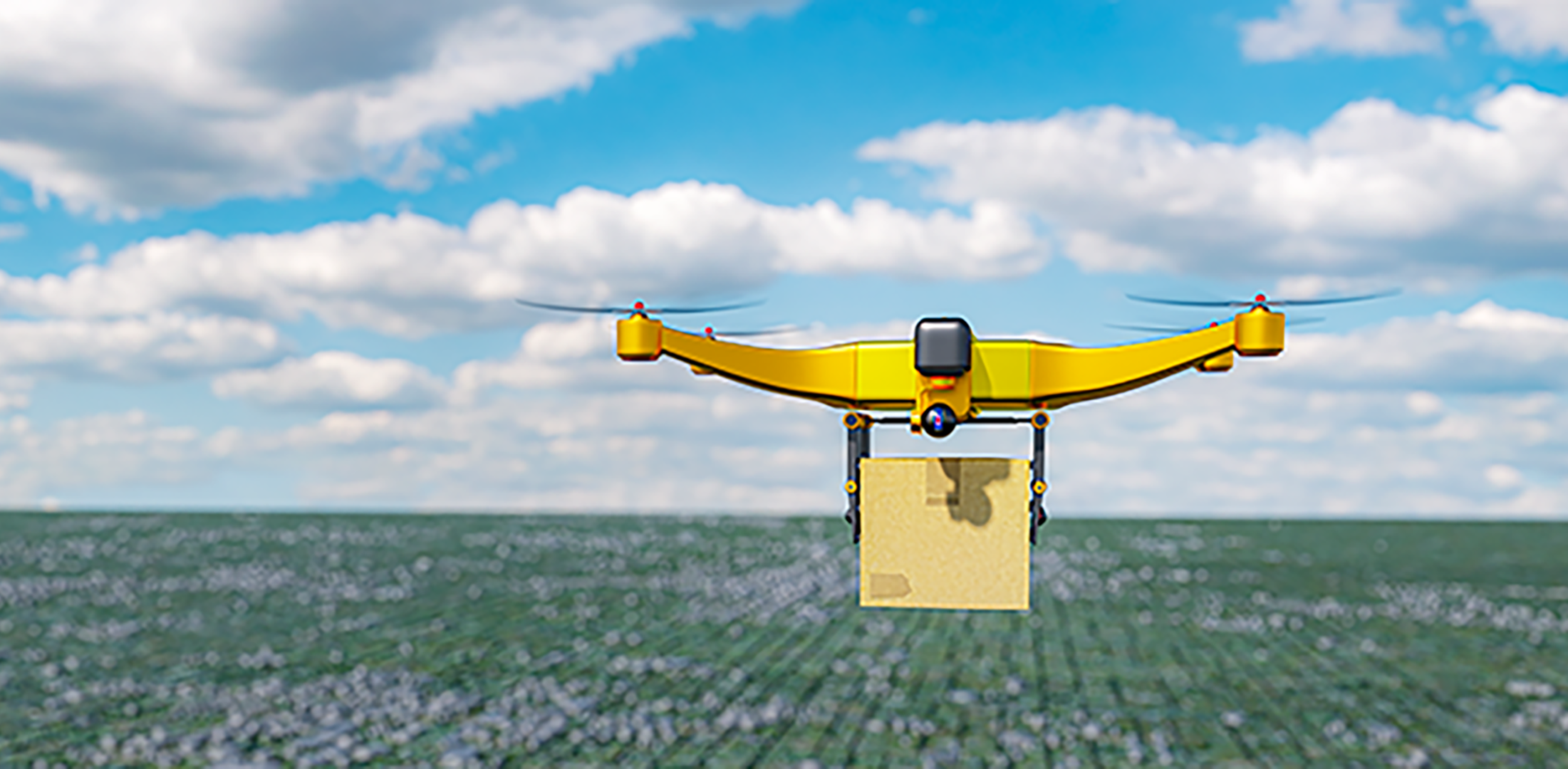 A yellow delivery drone flies over a field