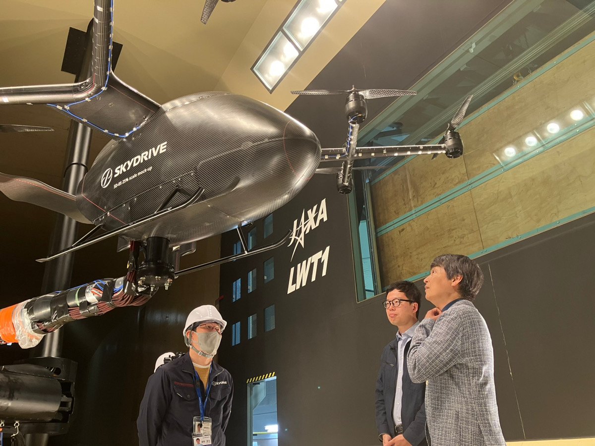 Venture capitalist Kotaro Chiba (left) views a model of SkyDrive's SD-05 eVTOL aircraft.