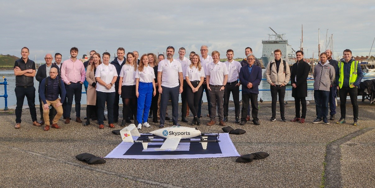 The Open Skies Cornwall team, including DronePrep chief innovation officer Karina Nasretdinova and CEO Gareth Whatmore (left to right in the foreground), is conducting flight trials using vehicles such as the Skyports Kookaburra Swoop drone.