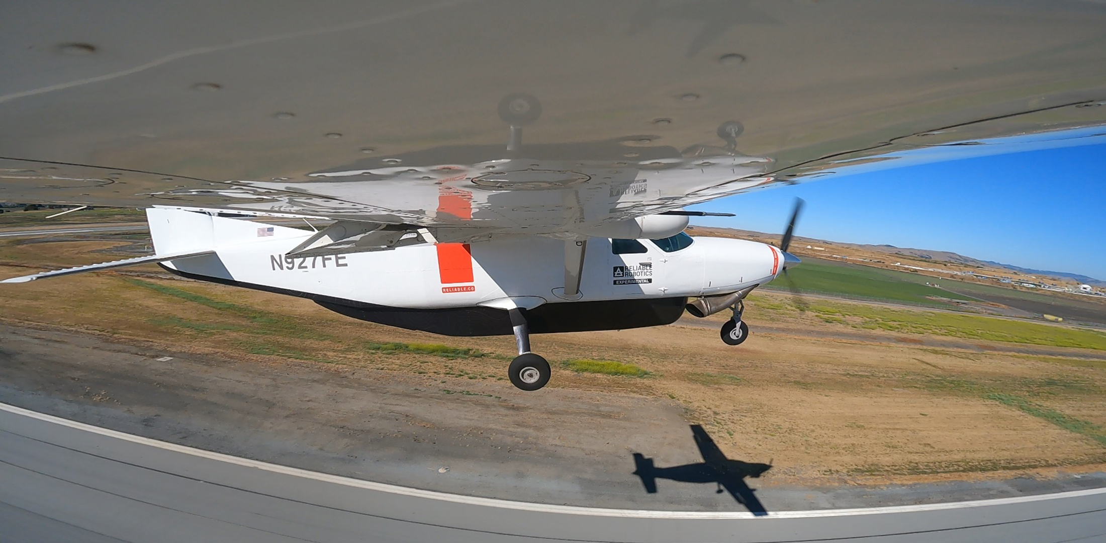 A view from under the wing of an airplane flying with Reliable Robotics' autopilot system