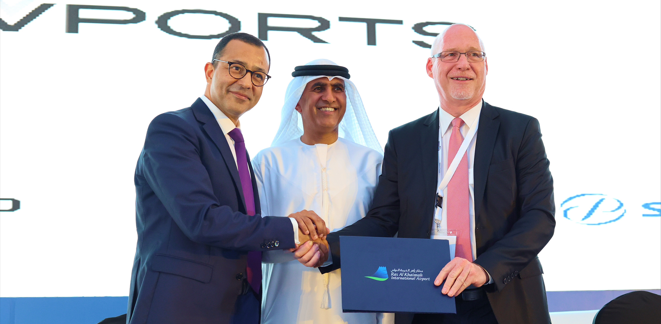 VPorts president and founder Fethi Chebil; His Highness Eng. Salem bin Sultan Al Qasimi, chairman of the Department of Civil Aviation in Ras Al-Khaimah; and Ralf Schustereder, CEO of Ras Al-Khaimah Airport, shake hands at the Arab Aviation Summit on March 8, 2023.
