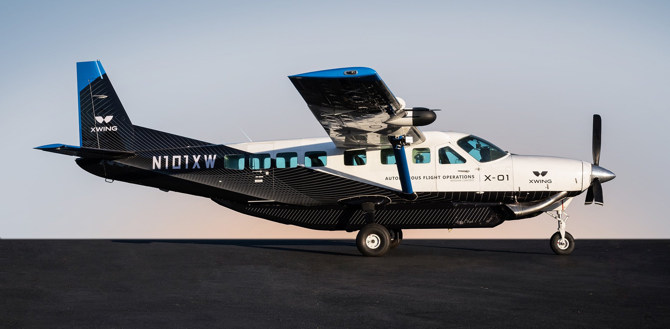 Xwing's experimental Cessna 208B Grand Caravan is pictured on9 the runway at sunset