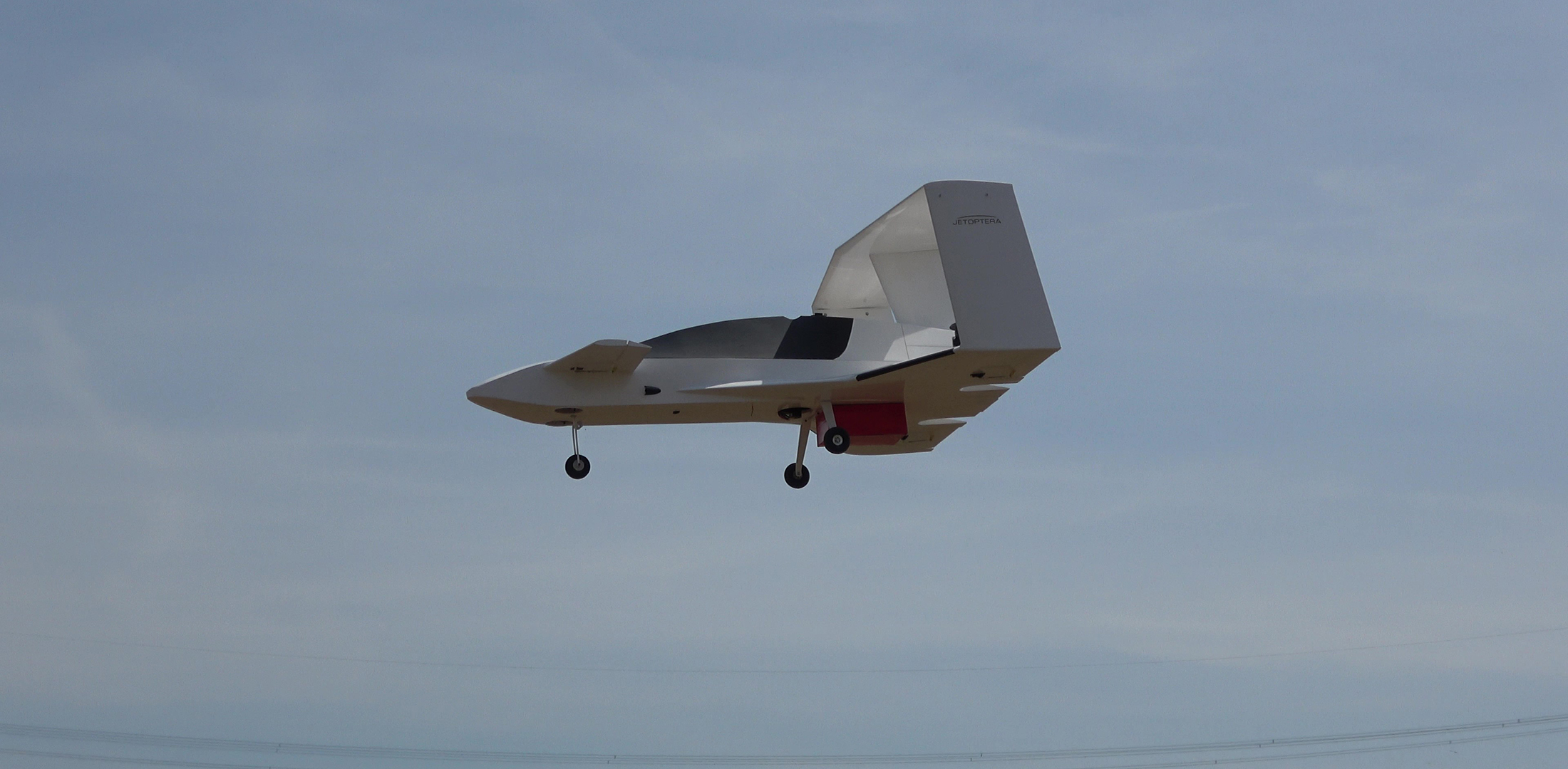 A quarter-scale model of Jetoptera's J-2000 prototype eVTOL aircraft is pictured during a test flight.