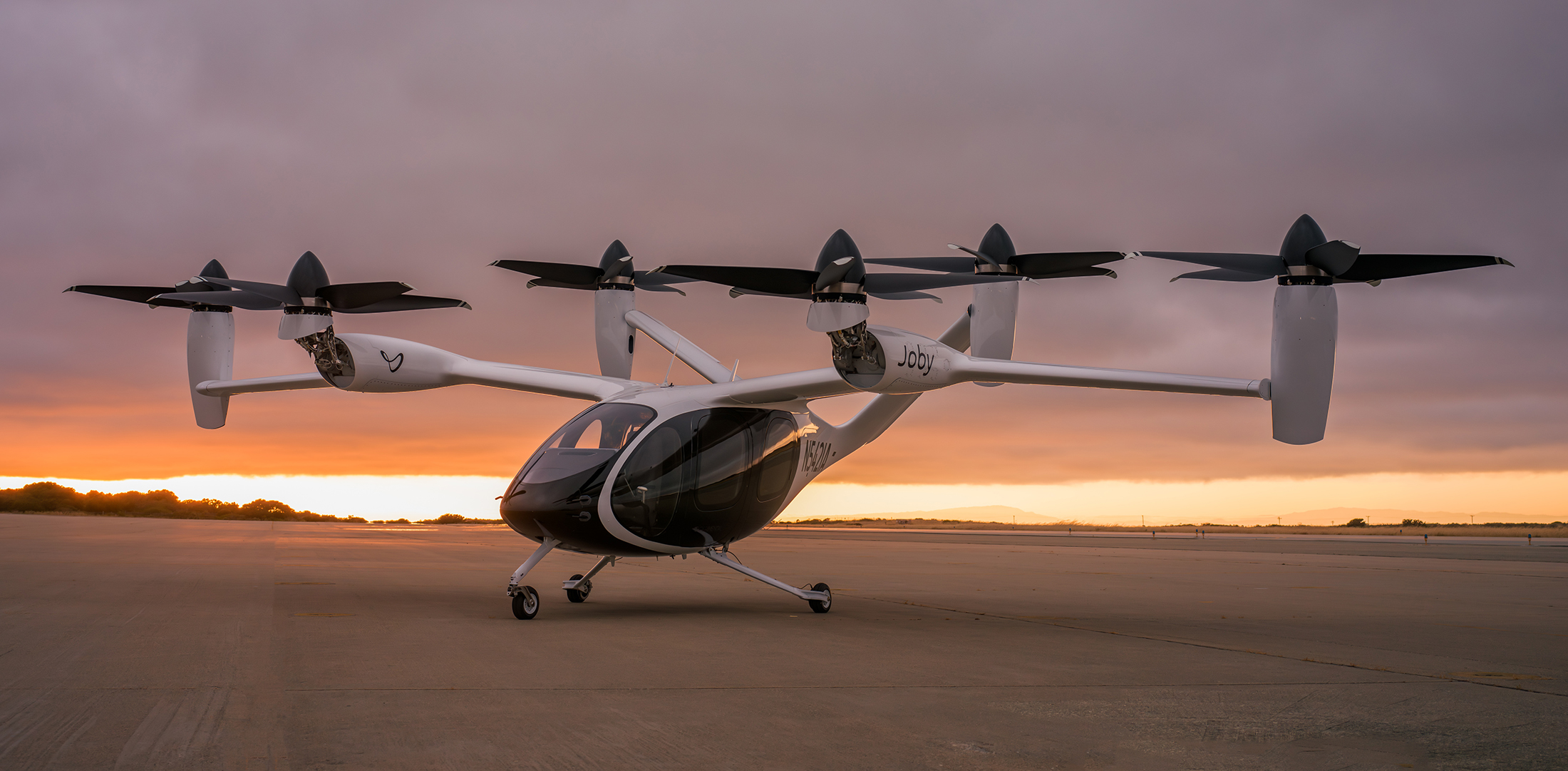Joby rolled out the first so-called "production prototype" of its eVTOL air taxi at the company’s manufacturing and flight testing facilities in Marina, California, on June 28, 2023. (Photo: Joby Aviation) Joby's first production prototype eVTOL air taxi is pictured on the tarmac