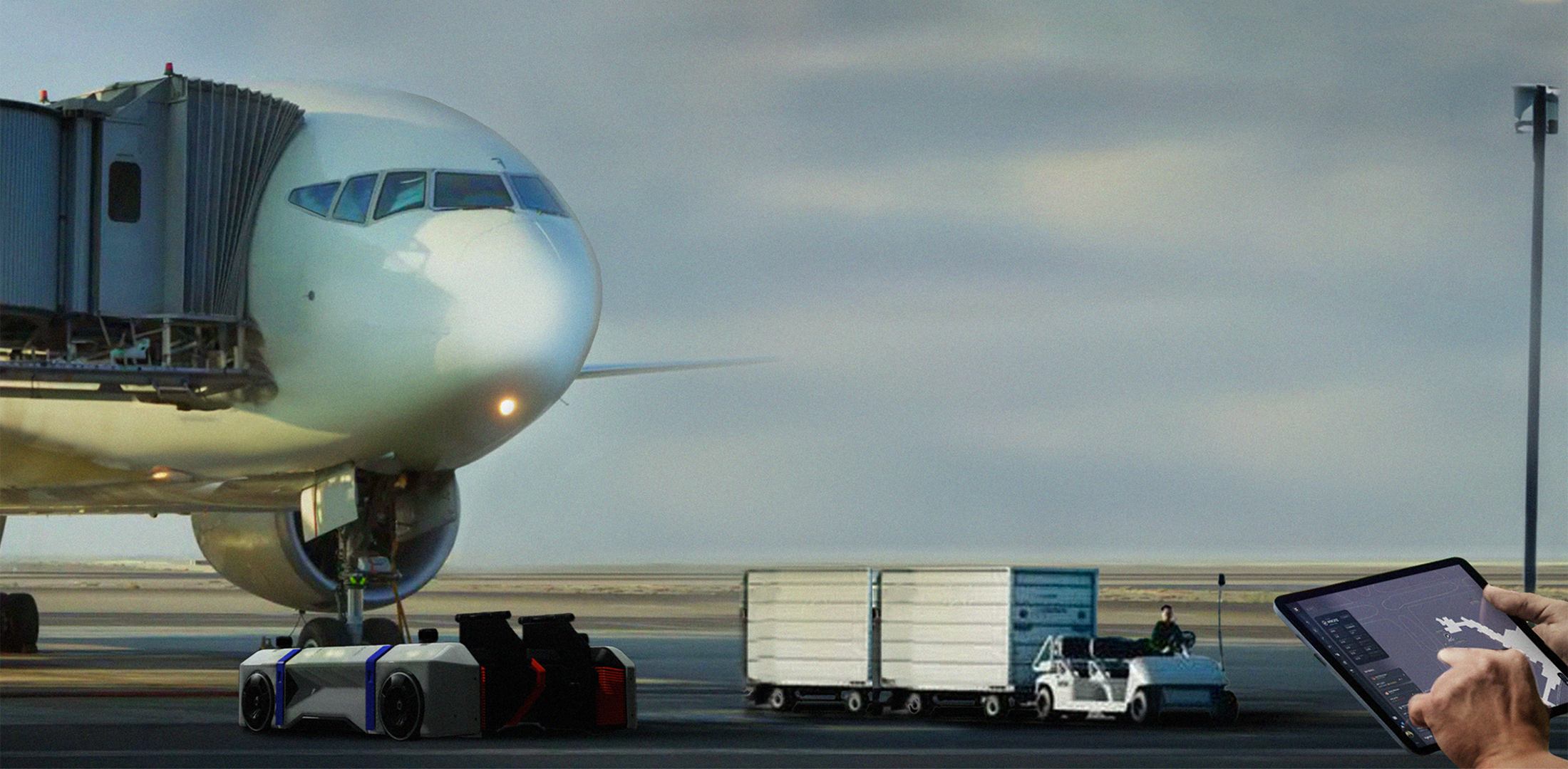 An airside employee looks at Moonware software on a tablet while standing in front of an airplane