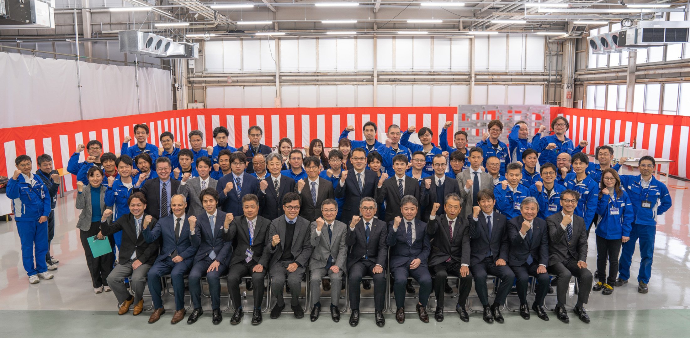 The Sky Works team poses for a photo in the factory where it is building the SD-05 eVTOL aircraft.